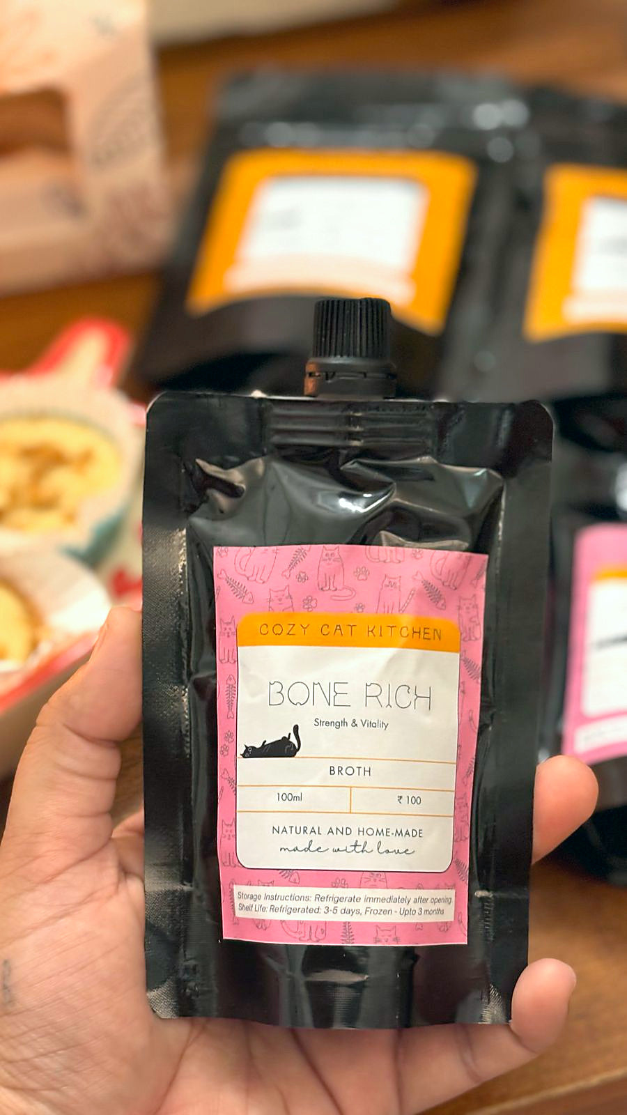 A pouch of Bone Rich broth held in a hand