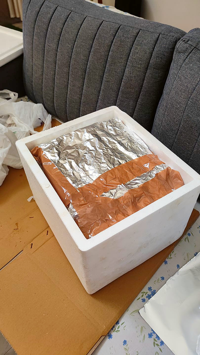 A thermocol box packed with a foil-wrapped parcel